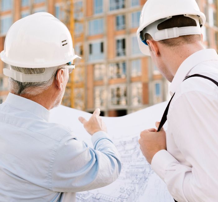 Engineers reviewing plans during Pre Purchase Building Inspection on-site